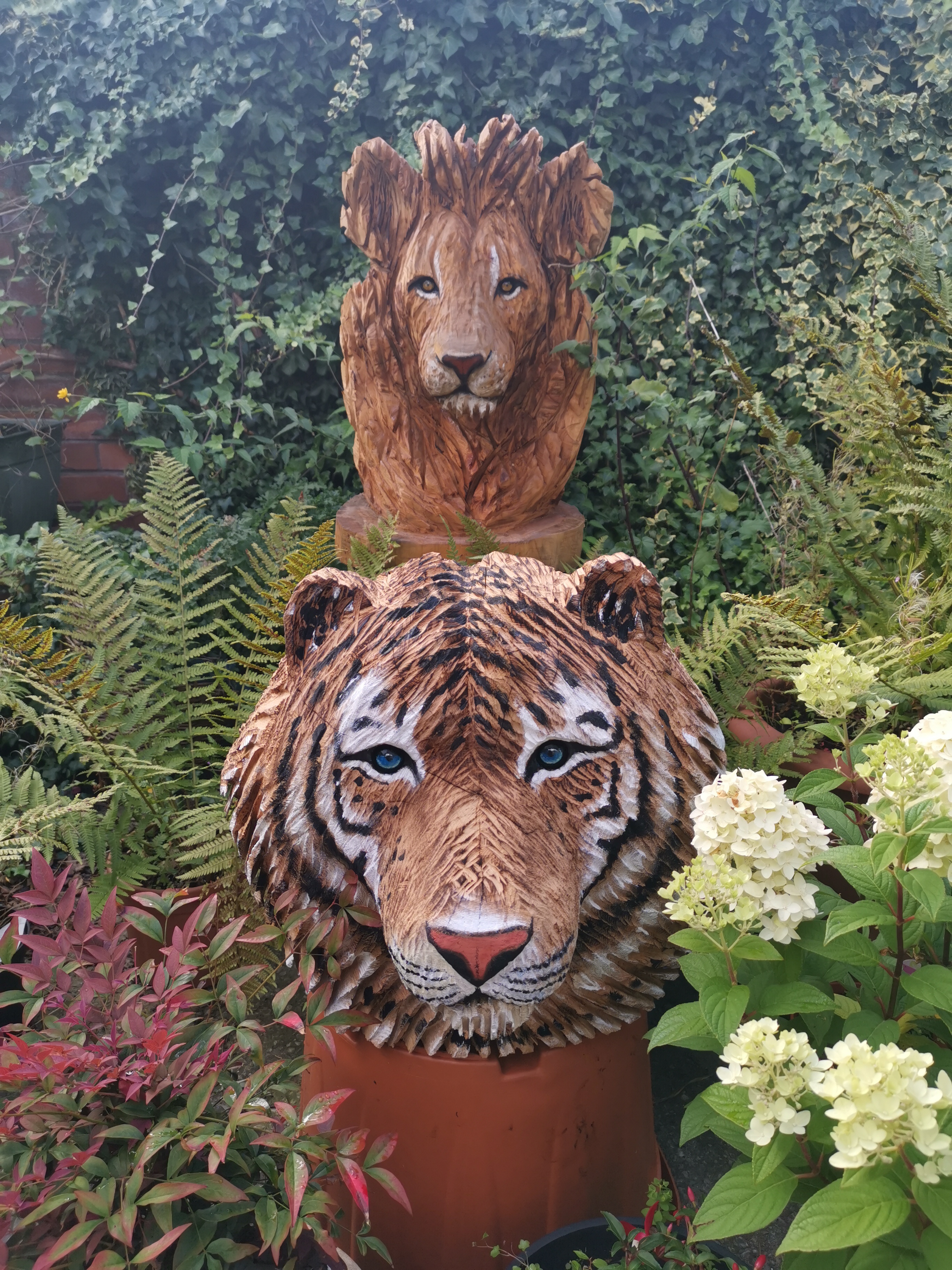 male tiger and Lion head carvings, life size