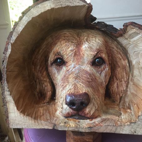 Dog head, carved into a log, with painted high lights